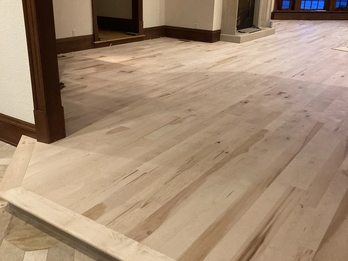 Maple hardwood planks installed across the same living room