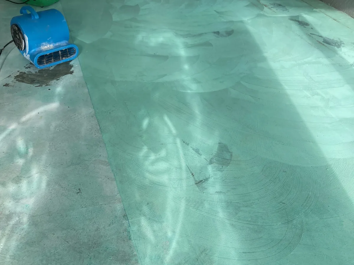 Moisture barrier drying under an air mover